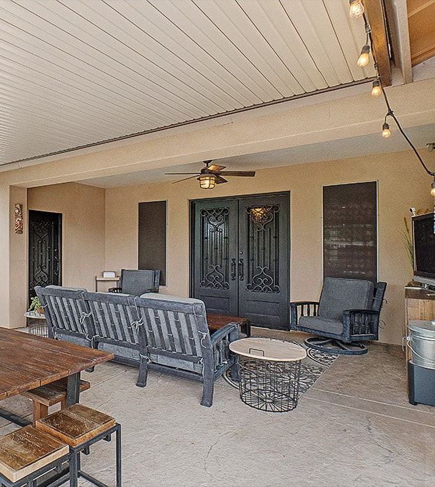 Older house with a concrete patio with furniture