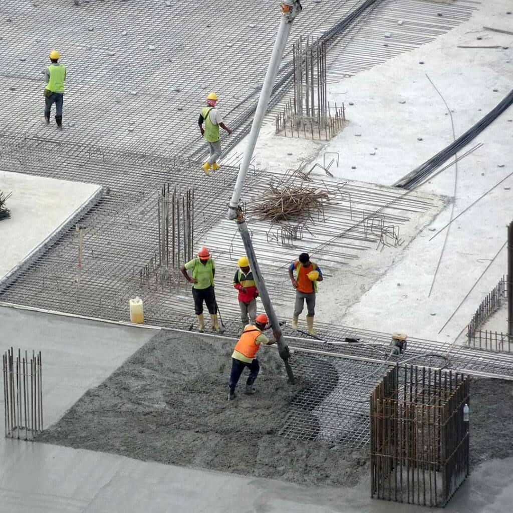 Workers pouring concrete on a commercial site